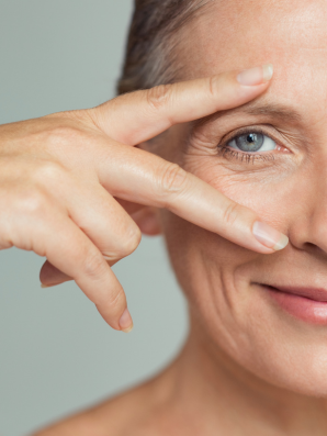 Smiling woman framing her eye—visual for ABBI Radiance Eye Contour Serum benefits of delicate under-eye skin highlighted—ABBI serum supports brightness, moisture, and protection.