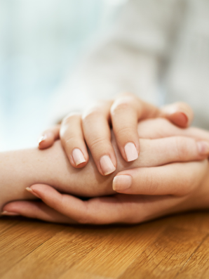 Caregiver gently holding hands—empathetic, dignified support with patience, validation, and connection.