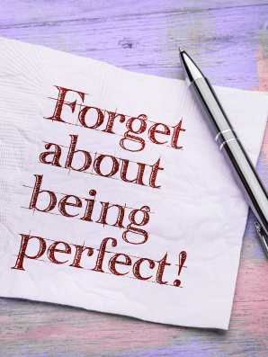 Motivational napkin quote: “Forget about being perfect,” encouraging imperfect progress.