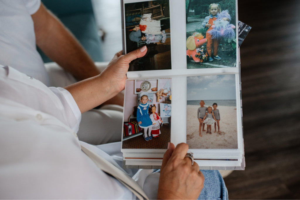 Caregiver viewing family photo album, protecting loved ones’ stories and memories with Forever.